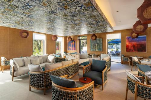 a lobby with couches and chairs and a ceiling with a mural at Hyatt Regency Zadar in Zadar