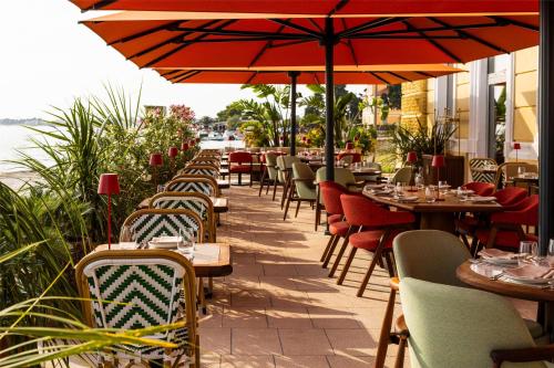 a restaurant with tables and chairs and an umbrella at Hyatt Regency Zadar in Zadar