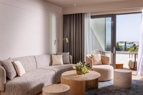 a living room with a couch and two chairs and a table at Hyatt Regency Zadar in Zadar