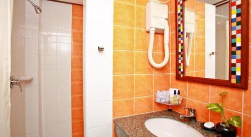 a bathroom with a sink and a mirror and a shower at Hua Hin Loft Managed by Loft Group in Hua Hin