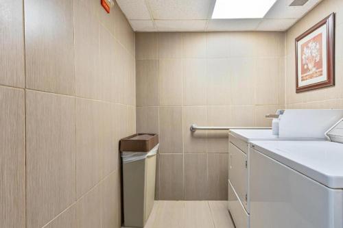 a bathroom with a washer and dryer in a room at Quality Inn Prattville I-65 in Prattville
