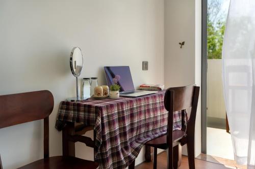a table with a laptop computer on top of it at Sanh Homestay in Hue