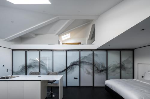 a bedroom with a bed and a desk in a room at Mont XIX Villa - Panoramic Sea & Mountain View in Dali Airport