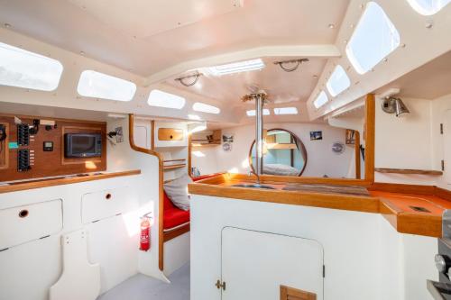 a view of the kitchen of a caravan with a sink at Voilier Pyman - Le Chant Des Voiles in Douarnenez