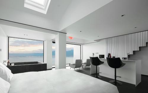 a bedroom with a bed and a view of the ocean at Mont XIX Villa - Panoramic Sea & Mountain View in Dali Airport