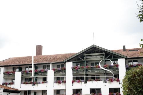 an apartment building with flowers on the balconies at Hotel Das Ludwig in Bad Griesbach