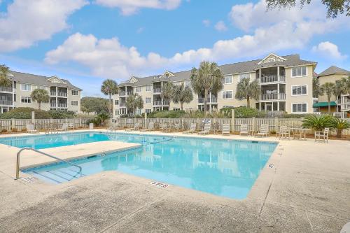 a swimming pool at a apartment complex with condos at Port O' Call E303 - Sensational Oceanview! Top Floor! in Isle of Palms