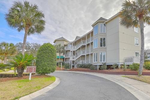 a building with palm trees next to a street at Port O' Call E303 - Sensational Oceanview! Top Floor! in Isle of Palms