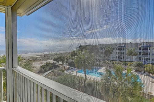 a balcony with a view of a resort and a swimming pool at Port O' Call E303 - Sensational Oceanview! Top Floor! in Isle of Palms