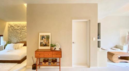 a bedroom with a bed and a table with a mirror at 오를 Orle in Kama-ri