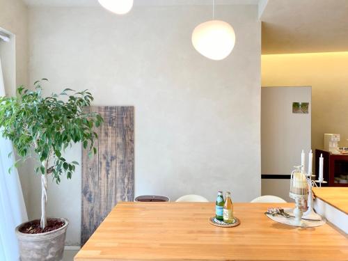 a wooden table in a kitchen with a potted plant at 오를 Orle in Kama-ri