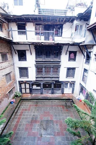 a large white building with balconies and a courtyard at The Newari dream in Old Patan-high ceiling & charm in Pātan