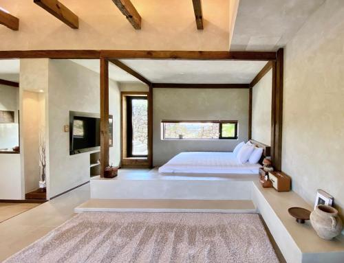 a bedroom with a large bed and a large window at 오를 Orle in Kama-ri