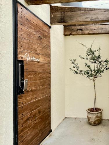 a tree in a pot next to a wall at 오를 Orle in Kama-ri