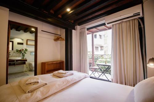 a bedroom with a bed and a large window at The Newari dream in Old Patan-high ceiling & charm in Pātan