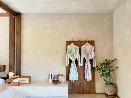 a room with two dresses hanging on a wall at 오를 Orle in Kama-ri