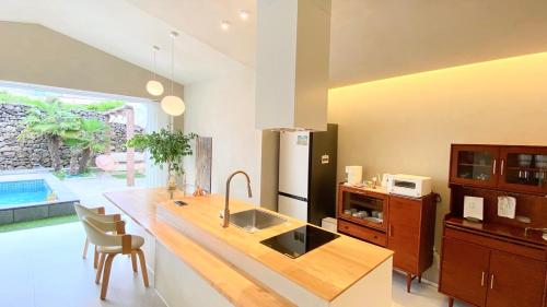 a kitchen with a counter with a sink and a counter sidx sidx sidx at 오를 Orle in Kama-ri