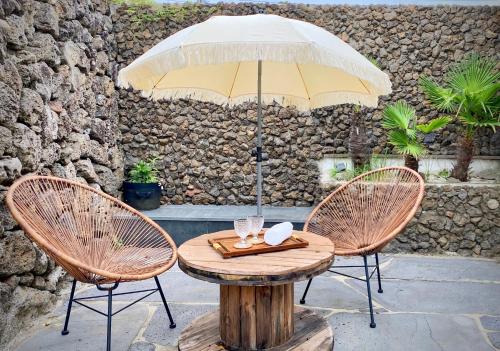 a table with two chairs and an umbrella at 오를 Orle in Kama-ri