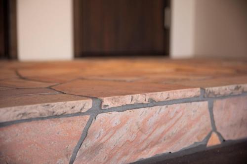 a close up of a brick floor with a door at RouTe5 in Matsumoto