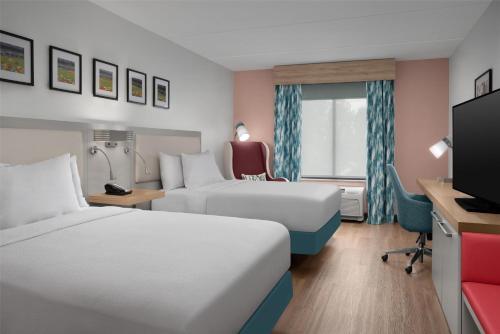 a hotel room with two beds and a tv at Hilton Garden Inn Atlanta West/Lithia Springs in Lithia Springs