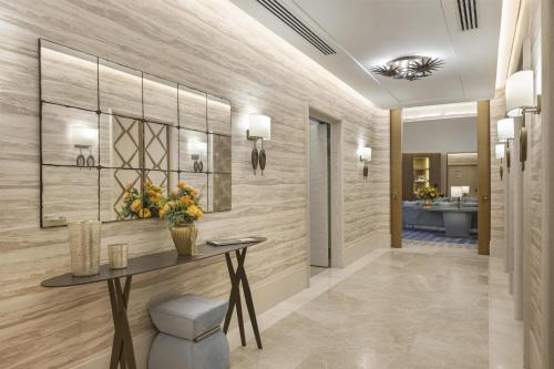 a hallway with a table and a bathroom at Hilton Istanbul Bosphorus in Istanbul