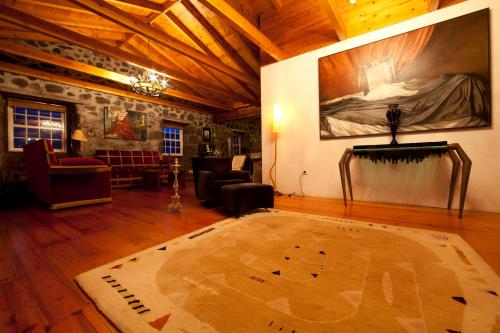 a living room with a large painting on the wall at Pocinhobay in Madalena