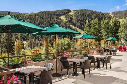 a patio with tables and chairs and umbrellas at Hyatt Place Keystone - Dillon in Keystone