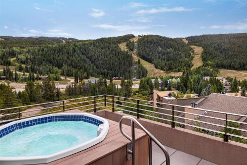 a hot tub on a balcony with a view of a mountain at Hyatt Place Keystone - Dillon in Keystone
