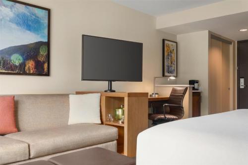 a living room with a couch and a tv at Hyatt Place Keystone - Dillon in Keystone