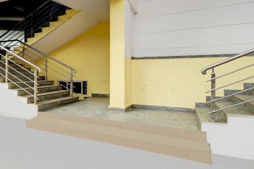 an empty room with stairs in a building at Collection O Abbigere MLV Grand in Jālahalli