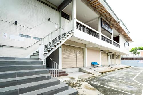 a building with a staircase in a parking lot at At Gate Suvarnabhumi-สุขุมวิท 77 in Lat Krabang