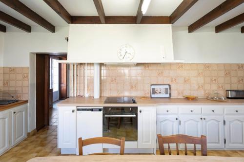 a kitchen with white cabinets and white appliances at Gite de charme aux portes du Gers in Lagrange