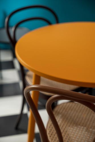 a table and a chair in a room at Mode Eco Mood Hotel - Adults Friendly in Rimini