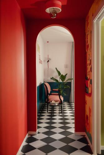 a red hallway with a black and white checkered floor at Mode Eco Mood Hotel - Adults Friendly in Rimini