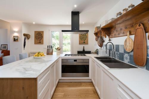 a kitchen with a sink and a stove top oven at Casita in Gratteri