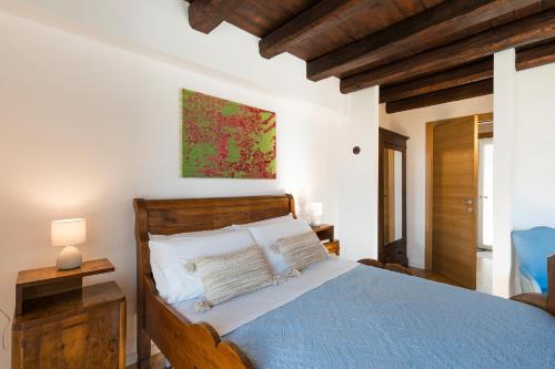 a bedroom with a bed with a blue comforter at Casita in Gratteri