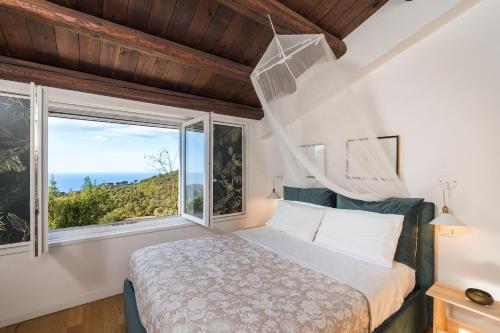 a bedroom with a bed and a large window at Casita in Gratteri