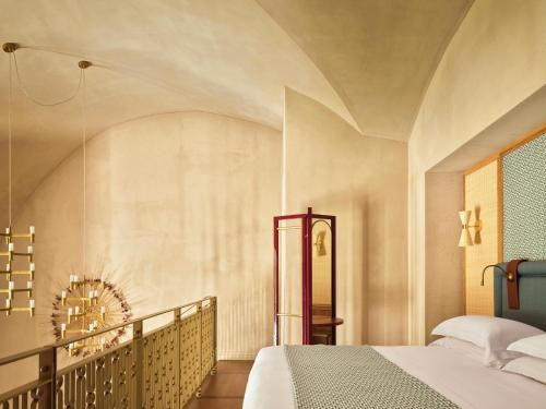 a bedroom with a bed and a staircase at VISTA Ostuni in Ostuni