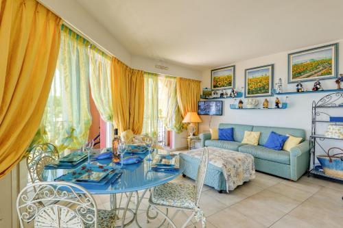 a living room with a blue table and a couch at Victoria Beach Apartments in Menton