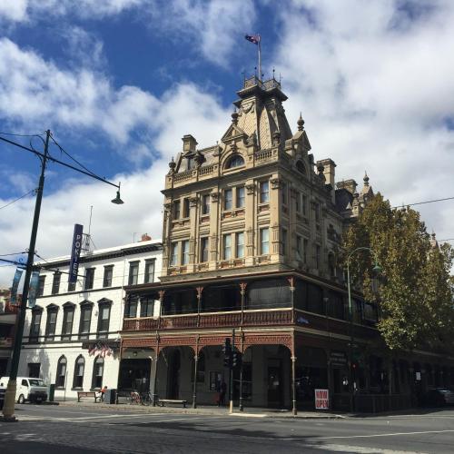 a large building on the corner of a street at The Hotel Shamrock in Bendigo