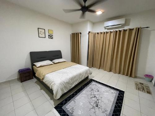 a bedroom with a bed and a ceiling fan at D'Haira Homestay Port Dickson Mu5lim Only in Port Dickson