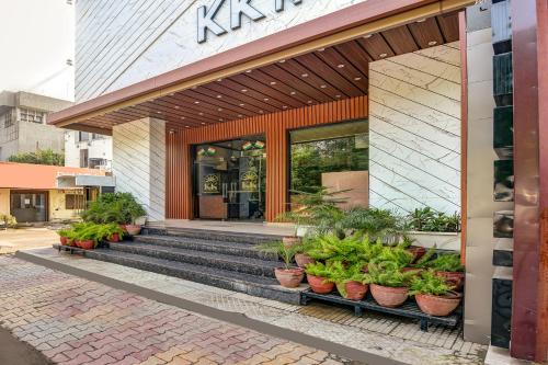 a store front with potted plants in front of it at FabHotel KK Continental 50 Meter from Railway Station - Amritsar in Amritsar