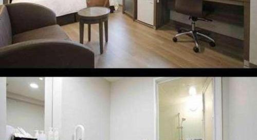 a room with a bed and a chair and a table at Hotel Sunoak Kashiwanoha in Kashiwa