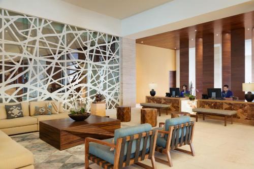 a lobby of a hotel with a table and chairs at Turquoize at Hyatt Ziva Cancun - Adults Only - All Inclusive in Cancún