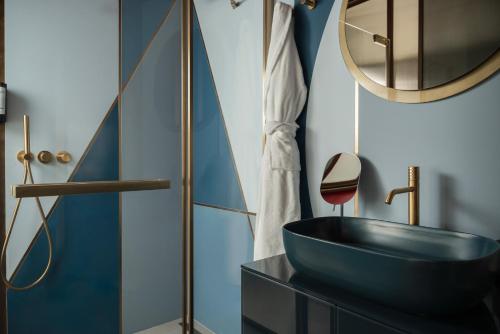a bathroom with a black sink and a mirror at Mode Eco Mood Hotel - Adults Friendly in Rimini