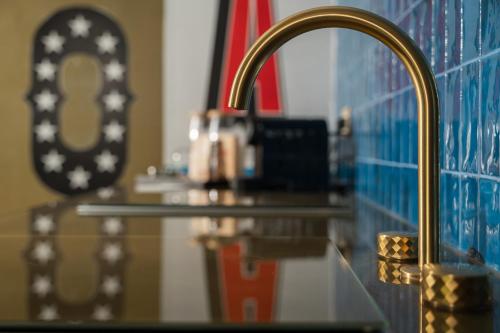 a bathroom counter with a sink and a faucet at Mode Eco Mood Hotel - Adults Friendly in Rimini