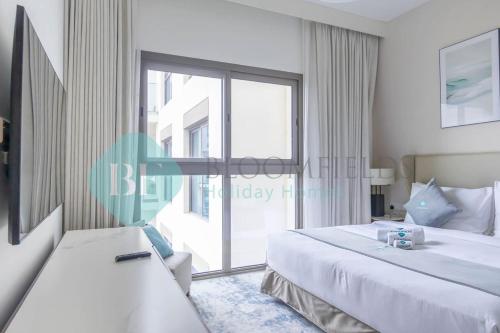 a bedroom with two beds and a large window at Beach Resort Address Luxury 2BR with Maid Sea View in Fujairah