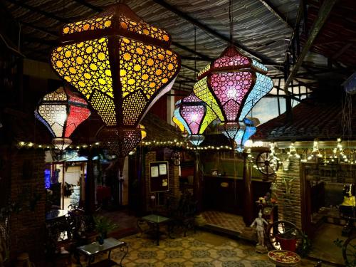 a group of lights hanging from the ceiling of a store at Hotel Mahabs in Mahabalipuram