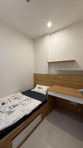 a small room with two beds and a desk at Moon Homestay 0308 in Gia Lâm Pho