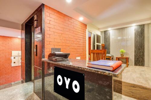 a sign on a counter in a room at Hotel O Roux residency in New Delhi